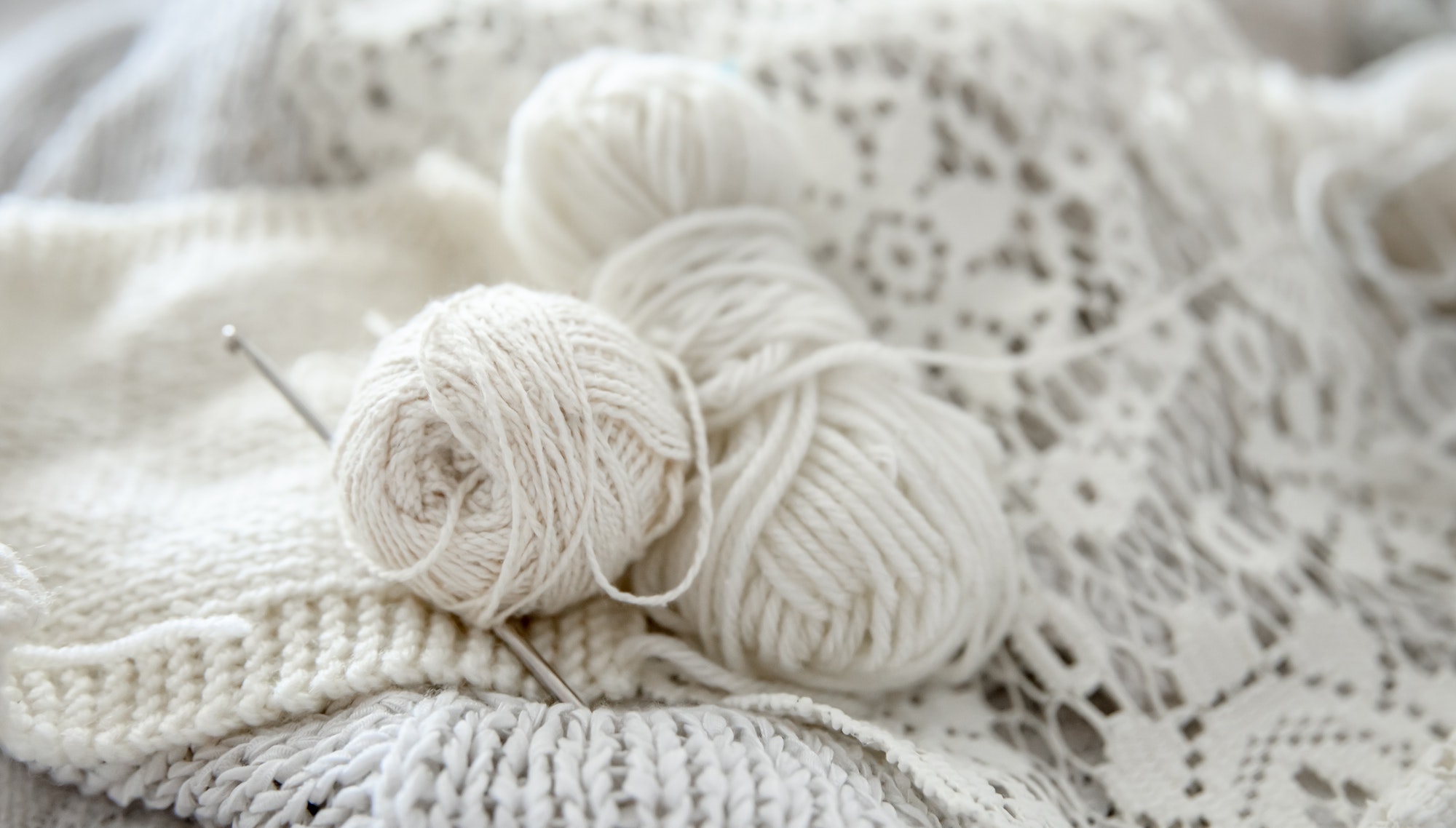 Close-up of crochet threads and handmade products.